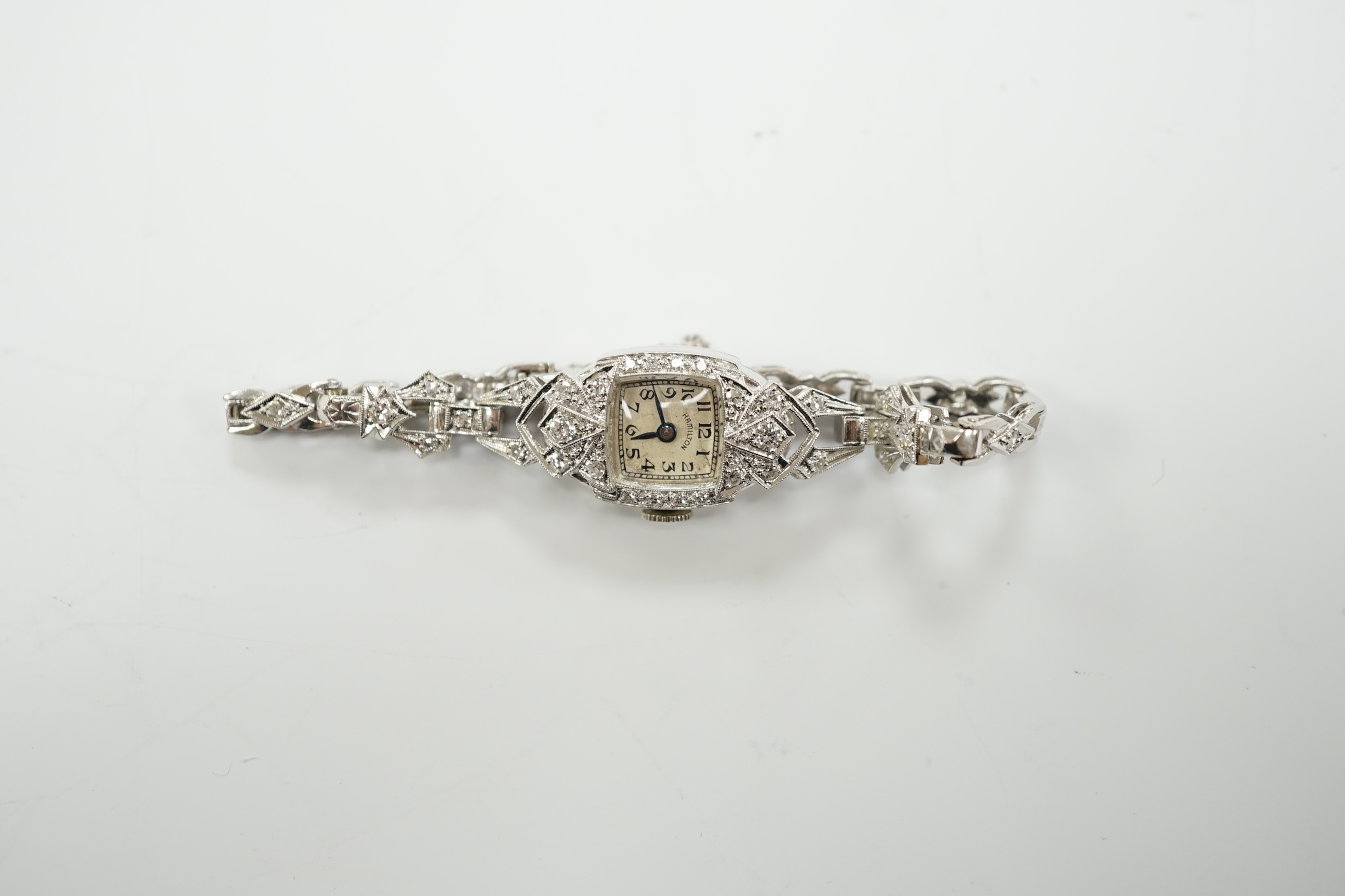 A lady's white metal (stamped irid and platinum) and diamond cluster set manual wind Hamilton cocktail watch, approx. 15cm, gross weight 24.6 grams.